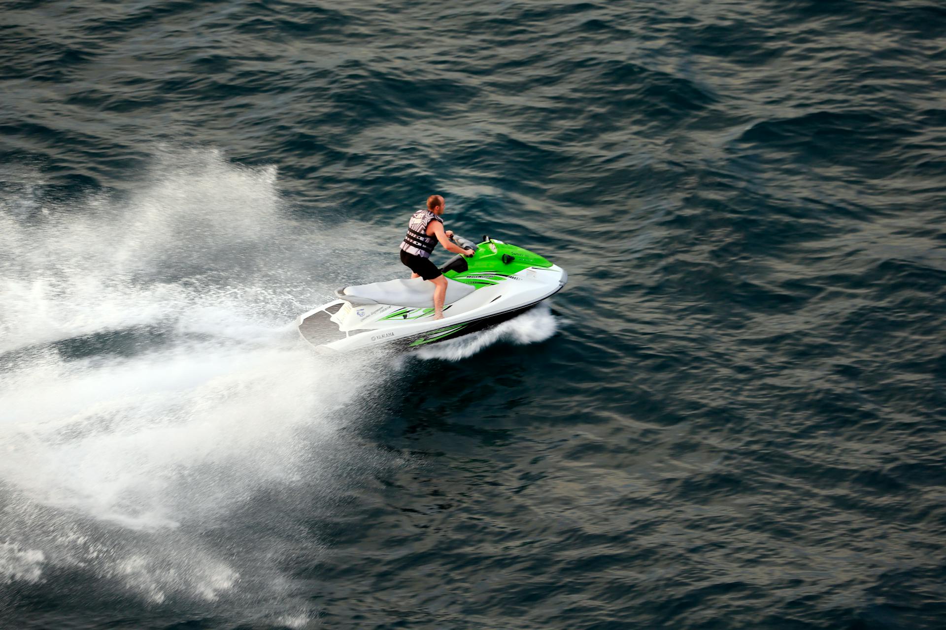A rider carving across the open Gulf on a jet ski